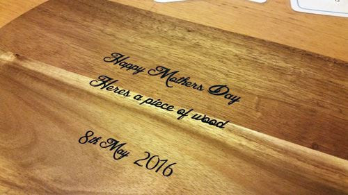 Handmade wooden breadboard with a personalised message